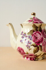 vintage teapot on white and  peachy background