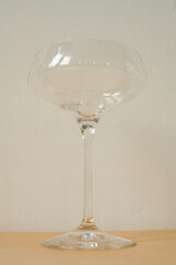 empty glass for cocktail on white and  peachy background