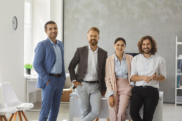 Portrait of happy motivated young multiethnic businesspeople pose together in modern office....