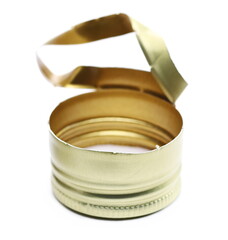Golden new metal twist bottle cap isolated on white, side view, macro