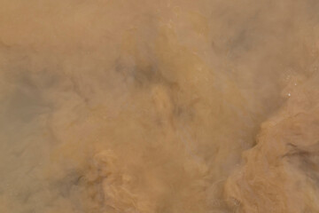 Cloudy, dirty water. Abstract brown background, pattern. Water surface.