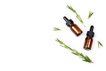 Natural rosemary essential oil or extract with fresh rosemary branches on white isolated background. Organic cosmetics flat lay image with copy space.