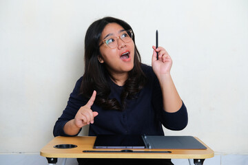 Young Asian woman got new idea expression when working using her mobile tablet gadget