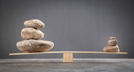 Balance stones on wooden scales.