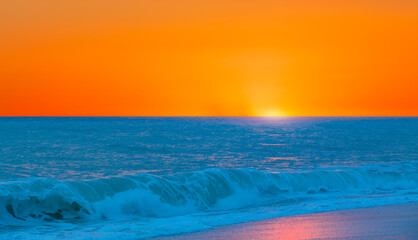Panorama of orange sunset over  Mediterranean sea with turquoise sea wave - Alanya, Turkey
