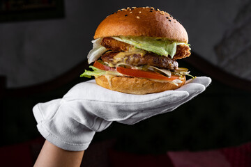 burger on the palm in a white glove, fast food, nuggets