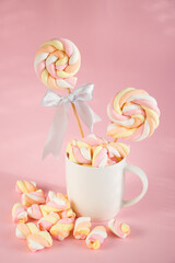 Sweet marshmallows on a pink pastel background. Childhood and birthday concept.