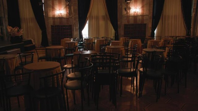 theater buffet without people, empty tables and chairs stand in dark indoors during the coronavirus pandemic