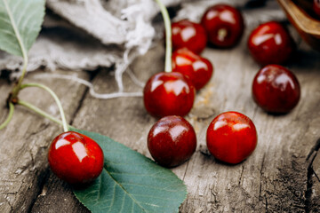 Ripe red cherries on a wooden table