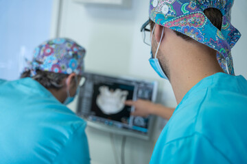 Dentists looking at an X-ray image