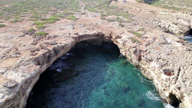 Drone footage of the wild Cretan groto, blue logon between rocky hills, coral reefs. Aerial mountain view. Crete island is a Mediterranean paradise. 