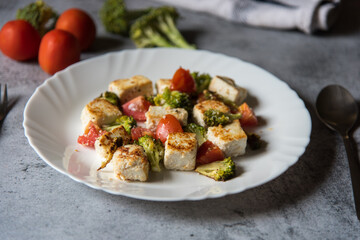 Close up of paneer or cottage cheese tikka in a white plate. Selective focus.