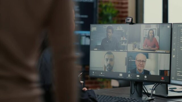 It startup employee in video call conference with client team discussing coding project deadline. Programer having online chat with clients and business owner about source code.