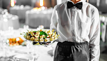 waiter holds plate with food. Restaurant service. buffet or catering.