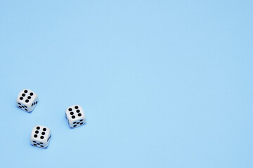 three dice with the same dropped out numbers lie on a blue background