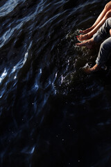 Fototapeta premium Couple refreshing with their feet in the river water