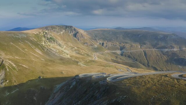 Amazing mountain road. 4K aerial drone view of Transalpina motorway from Romania during a beautiful summer sunrise.