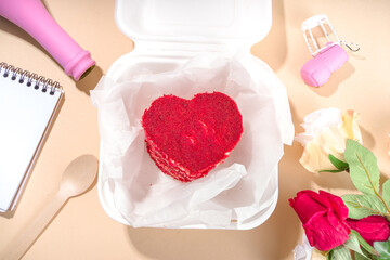 Red velvet heart shaped Valentine day bento cake, sweet dessert surprise gift for Valentines top view, with roses, champagne