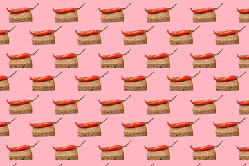 Pattern Bread croutons with pickled chili on a pink background.