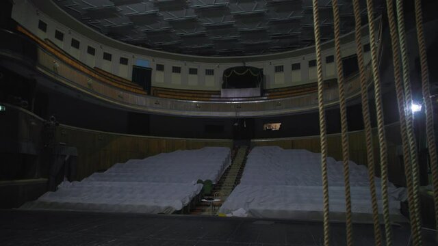 hall is without people during coronavirus pandemic, camera moves around the stage, empty seats are covered with cloth