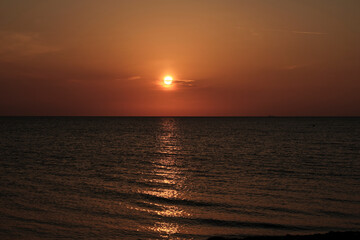 Romantic sunset over baltic sea at a pebble beach
