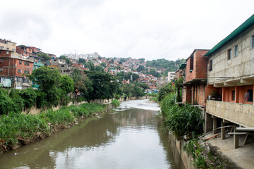 Fototapeta na wymiar End of the canalization of the Guaire River in the neighborhoods of Petare, body of wastewater from industries and Caracas population