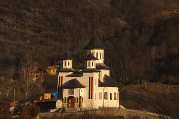 The Orthodox Church in a village in Romania. The flag of Romania on the walls of the church.