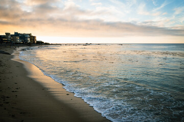 Small waves by shore at sunset over Algarrobo beach, Chile. Tourist destination, summer holidays concepts