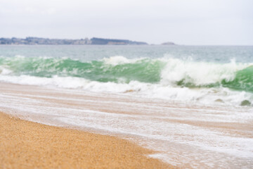 Rough sea waves by shore at empty beach on cloudy morning in Algarrobo, Chile. Natural landscape