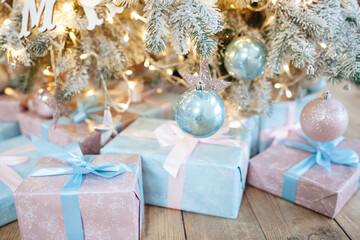 Fototapeta na wymiar Many beautiful gift boxes under Christmas tree. Smart interior. Christmas interior. Selective focus