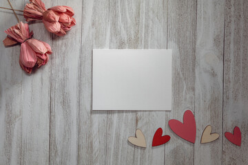 White card mockup on rustic wood background flat lay copy space.  Valentine's Day, Wedding, Birthday, Party, Sale, Romance, Celebration mockup to add logo, art and text.