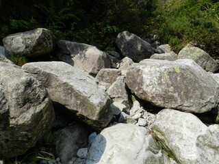Stones and rocks. An old crumbling wall with a beautiful, rough structure. 