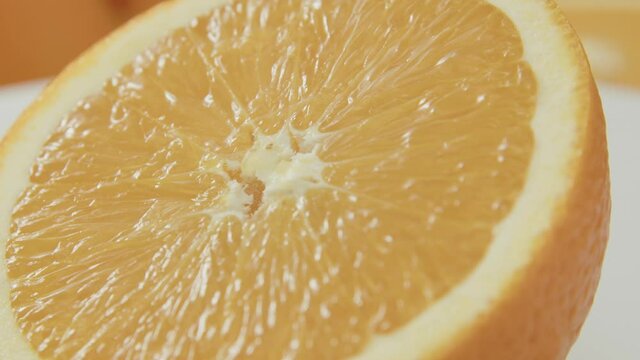 Close up shot of a spinning fresh slice of orange