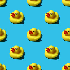 yellow rubber duck seamless pattern on a blue background