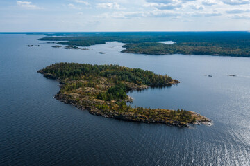 Fototapeta premium Aerial photography on Ladoga skerries. Ladoga Lake in Karelia in hot summer. Rocky wild islands in the middle of the lake. Russian nature