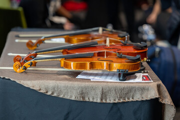 violins lined up on a table