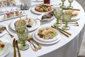 A bowl of Caesar chicken salad, on a wooden background. Festive salad.