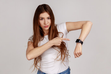 We have no time. Portrait of serious boss woman with dark hair pointing her finger at the...