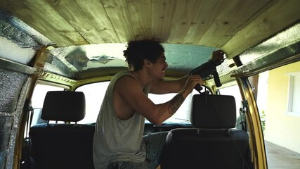 Man creating lumber ceiling in van