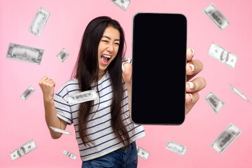 Online investment, winner overjoyed rich woman and money earning. Portrait of amazed young woman...
