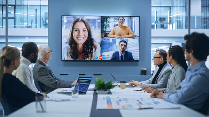 Video Conference Call in Office Boardroom Meeting Room: Executive Directors Talk with Group of...
