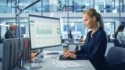 Diverse Modern Office: Confident Businesswoman Using Desktop Computer with Big Data Statistics, Graphs. Manager Working on e-Commerce Support, Project Marketing, Data Analysis