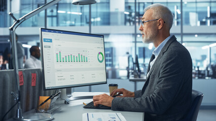 Corporate Office: Senior IT Specialist Using Desktop Computer with Big Data Statistics, Graphs....