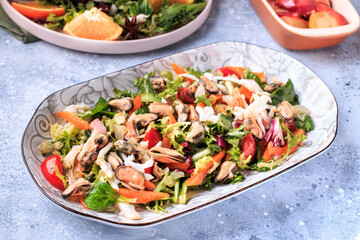 Homemade Seafood Salad mixed with fresh vegetable. Healthy food, sea food. Gray background. Top view.