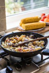 Home cooking. The process of cooking healthy, vegan food. Womens hands fried potato on a pan