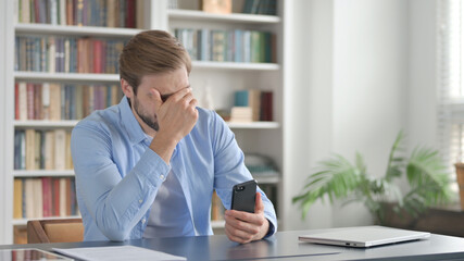 Upset Man Reacting to Loss on Smartphone 