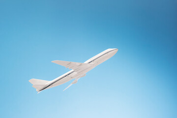Fototapeta na wymiar Plane taking off on blue background