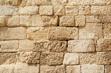 Old beige stone wall background texture