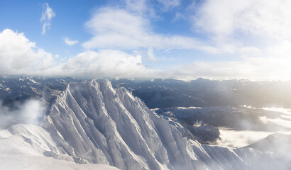 Fototapeta premium Aerial Panoramic View of Canadian Mountain covered in snow. Winter Season Cloudy Day Art Render. Located near Squamish, North of Vancouver, British Columbia, Canada. Nature Background Panorama