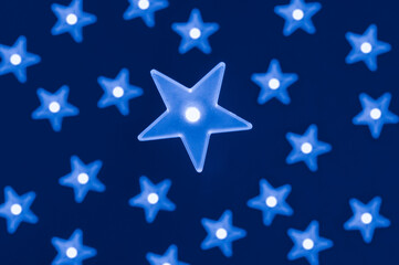 Fototapeta premium Blue star shaped led lights on dark blue background